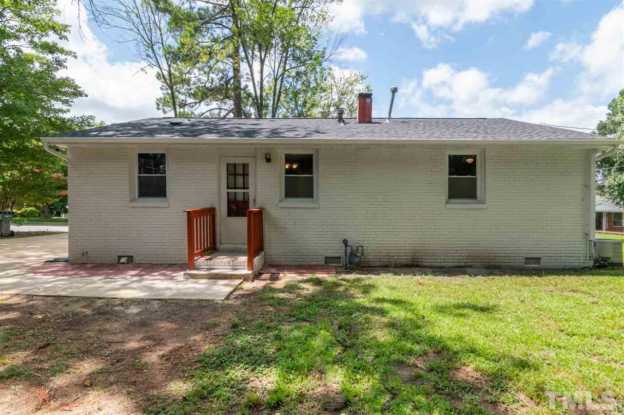 701 Hadley Road Raleigh, NC 27610 - Photo 13 of 16 a view of yellow house with a yard