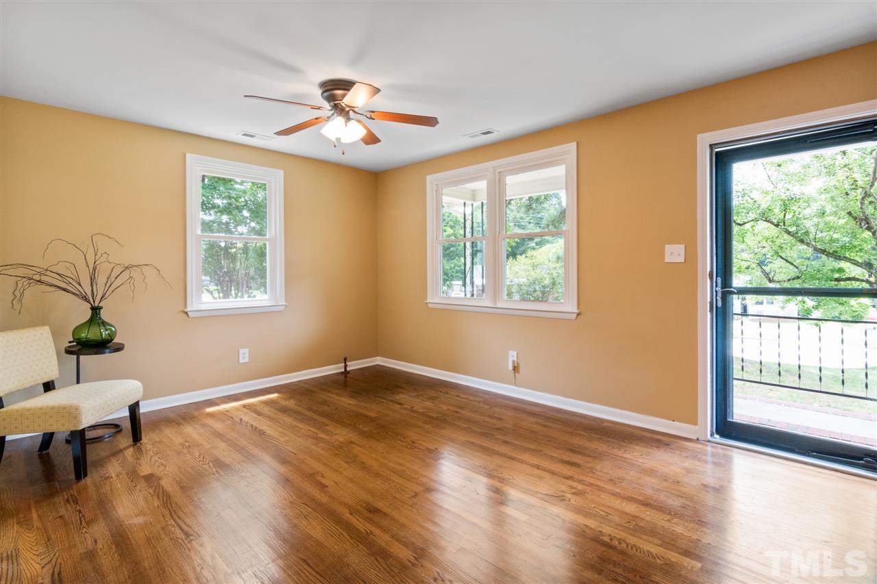 701 Hadley Road Raleigh, NC 27610 - Photo 3 of 16 a view of an empty room with a window and wooden floor