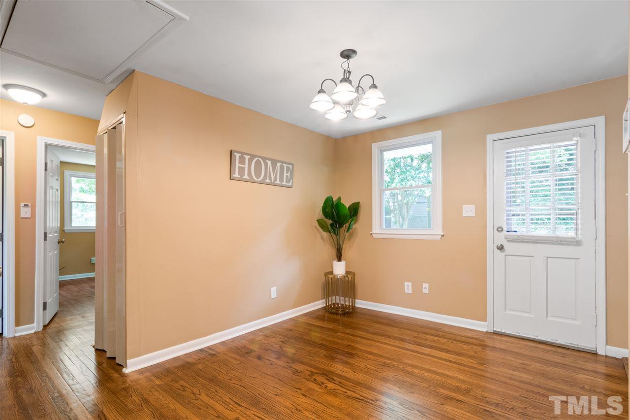 701 Hadley Road Raleigh, NC 27610 - Photo 5 of 16 a view of an empty room with wooden floor and a window
