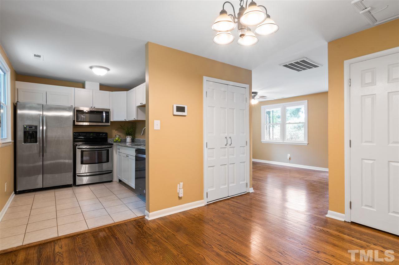 701 Hadley Road Raleigh, NC 27610 - Photo 6 of 16 a kitchen with granite countertop a refrigerator and a stove top oven