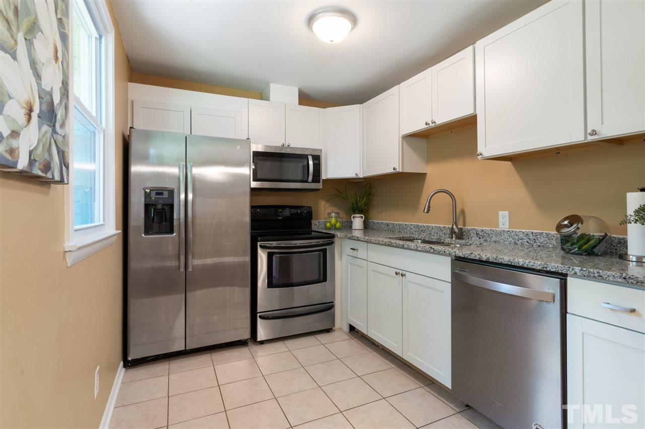 701 Hadley Road Raleigh, NC 27610 - Photo 7 of 16 a kitchen with stainless steel appliances granite countertop a refrigerator sink and microwave