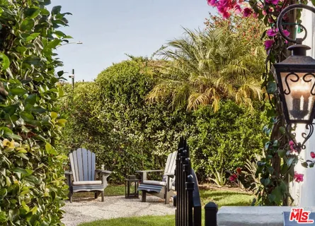 a view of a chairs and table in a backyard