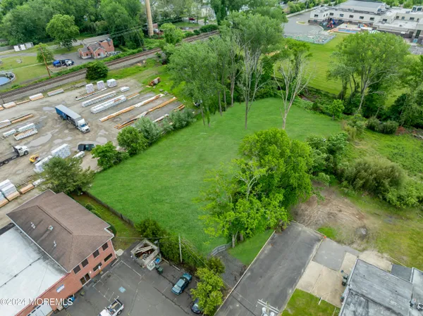 an aerial view of a house with a yard basket ball court and outdoor seating
