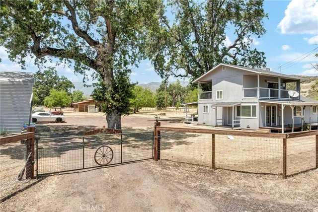 a view of a house with yard and sitting area