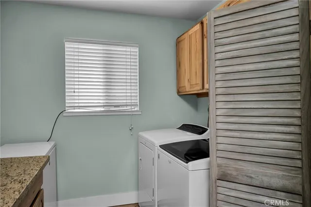 a bathroom with a granite countertop sink and mirror
