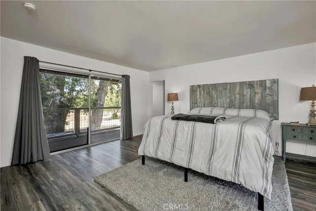 a spacious bedroom with a bed and a large window