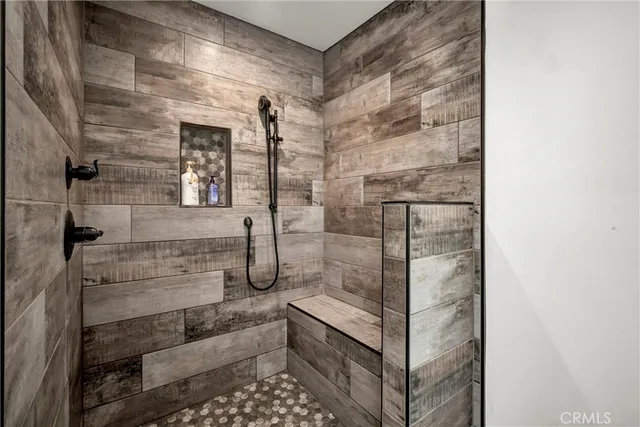 a bathroom with a shower and mirror