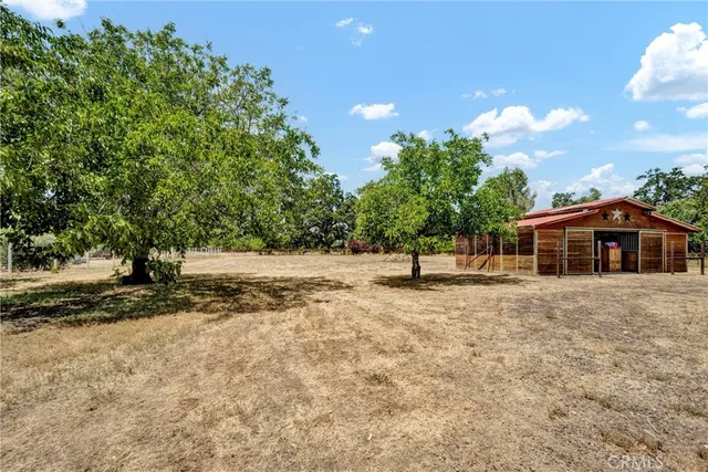 a view of a deck with table and chairs with wooden floor and fence