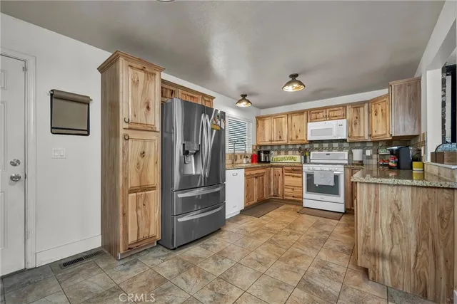 a kitchen with stainless steel appliances a refrigerator sink and cabinets