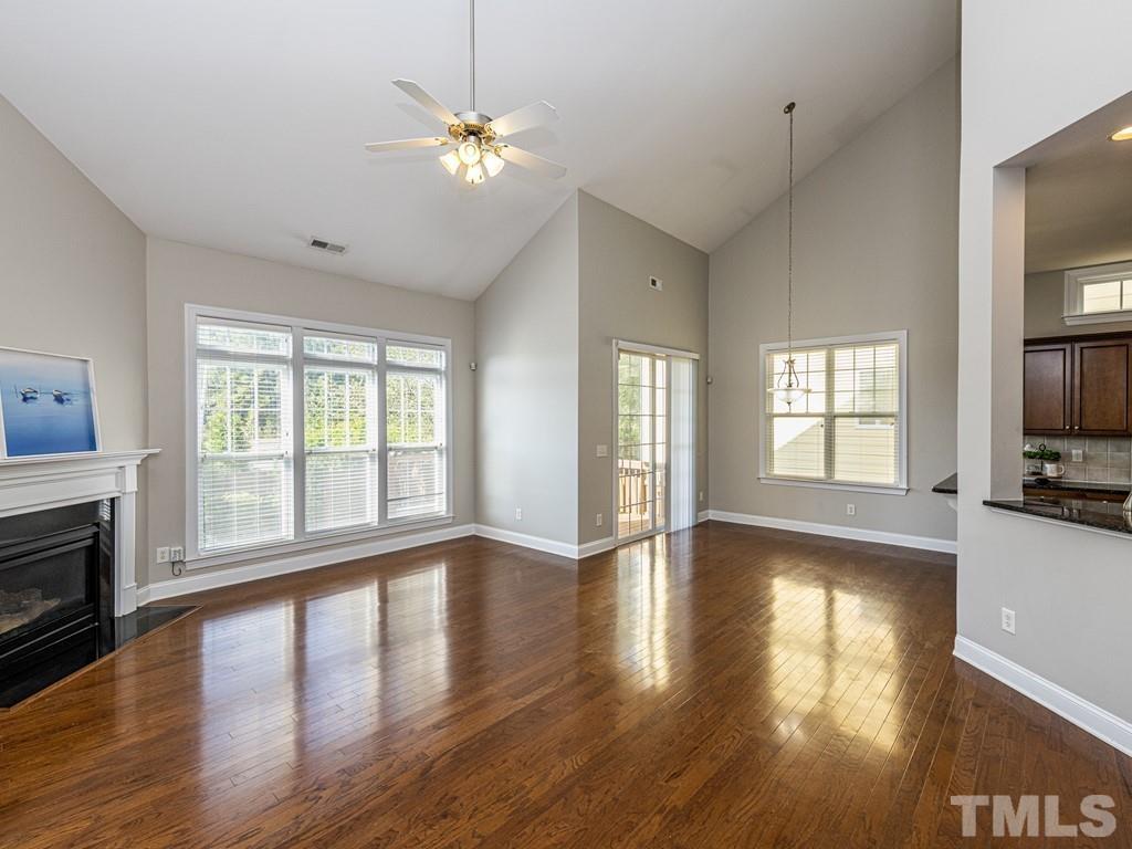 1136 Chapanoke Road Raleigh, NC 27603 - Photo 12 of 30 a view of an empty room with wooden floor and a window