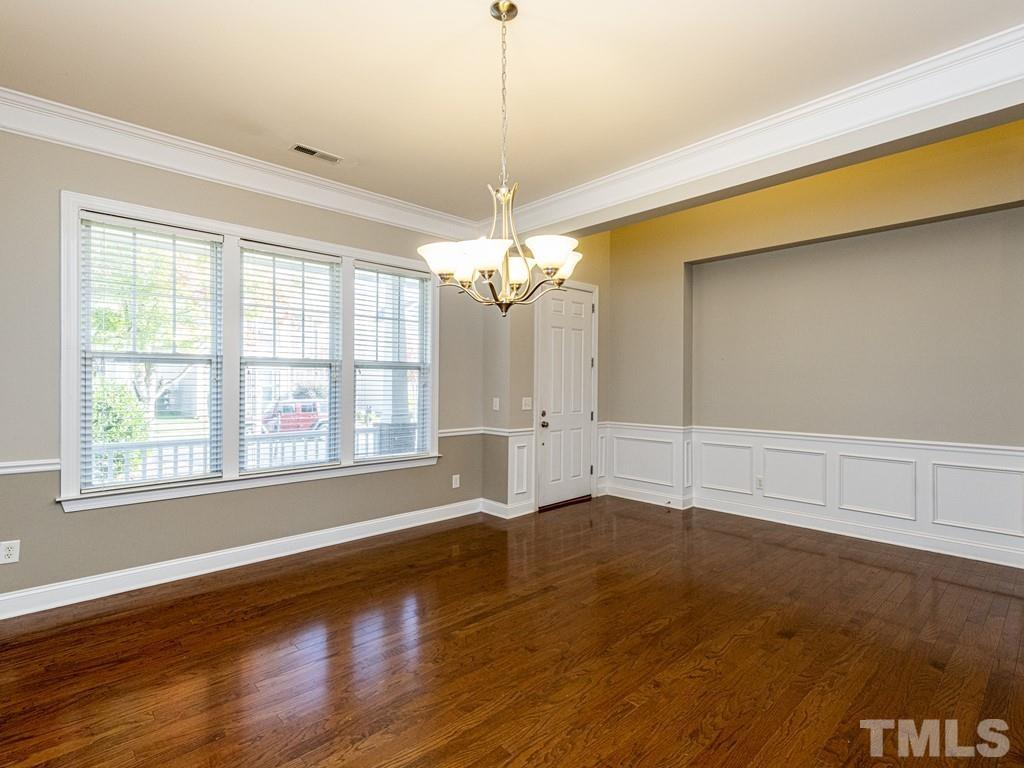 1136 Chapanoke Road Raleigh, NC 27603 - Photo 13 of 30 a view of livingroom with window wooden floor and chandelier