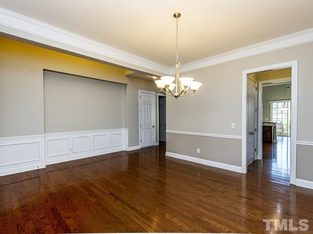 1136 Chapanoke Road Raleigh, NC 27603 - Photo 14 of 30 a view of an empty room with window and wooden floor
