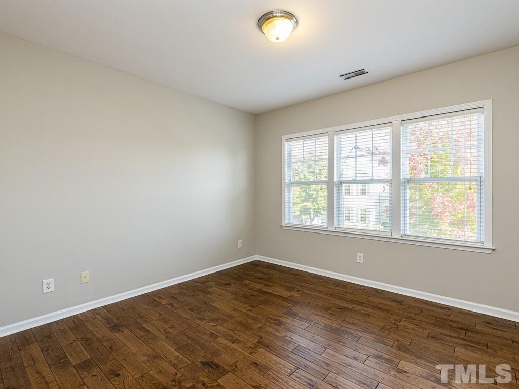 1136 Chapanoke Road Raleigh, NC 27603 - Photo 20 of 30 an empty room with wooden floor and windows