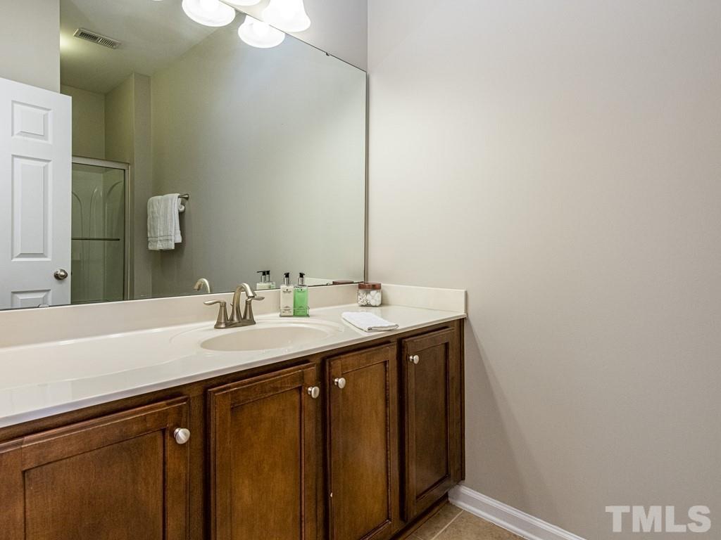 1136 Chapanoke Road Raleigh, NC 27603 - Photo 24 of 30 a bathroom with a sink and a mirror