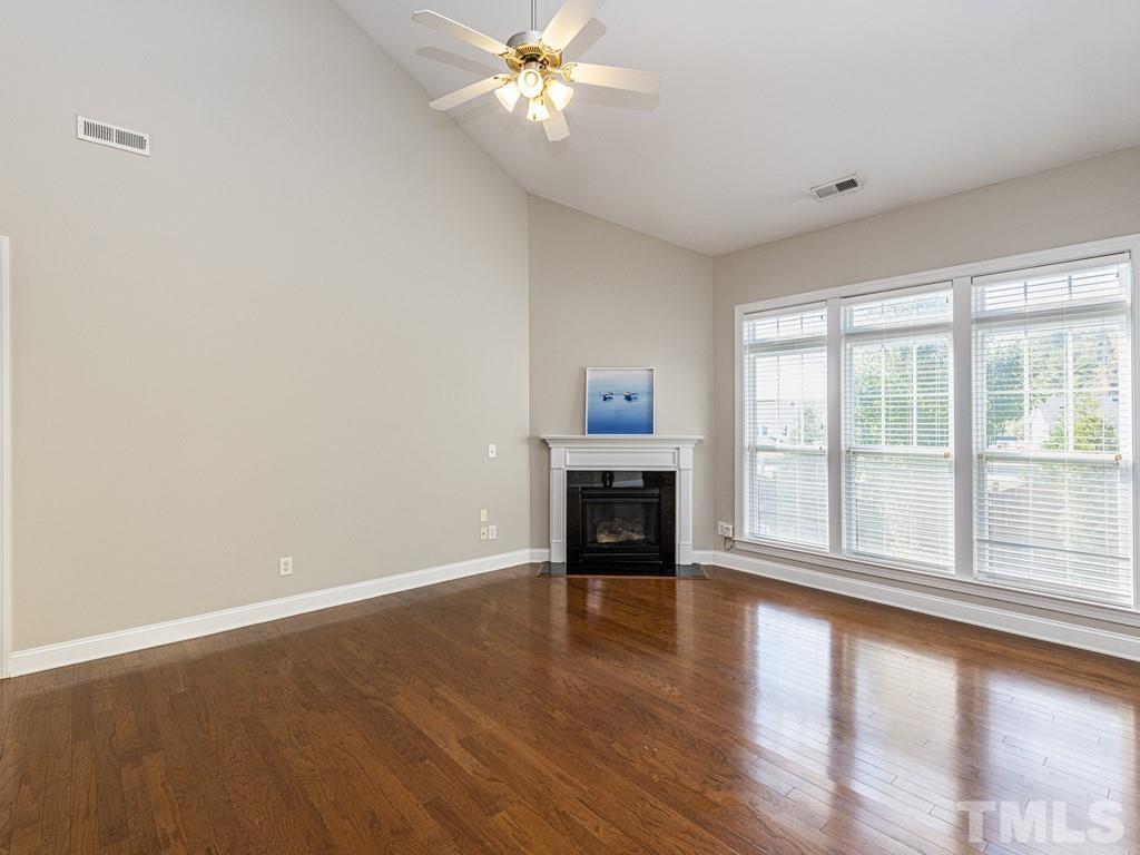 1136 Chapanoke Road Raleigh, NC 27603 - Photo 10 of 30 a view of an empty room with wooden floor and a window