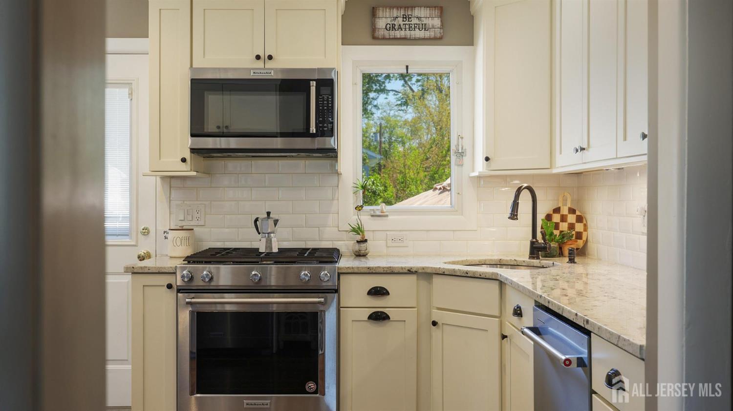 47 Miliken Road Colonia, NJ 07067 - Photo 15 of 40 a kitchen with stainless steel appliances granite countertop a sink stove and microwave