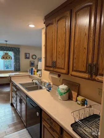 a kitchen with a sink and a stove top oven
