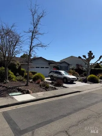 a side view of a house with a yard