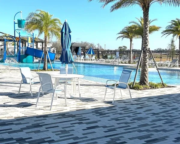 a kitchen with a sink a stove top oven and refrigerator