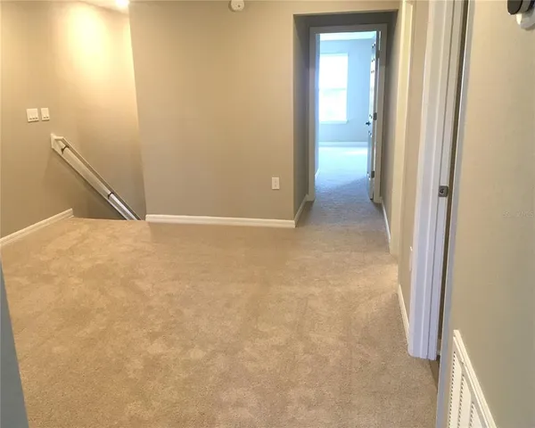 an empty room with closet and mirror