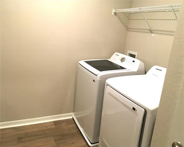 a view of a livingroom with wooden floor and cabinet