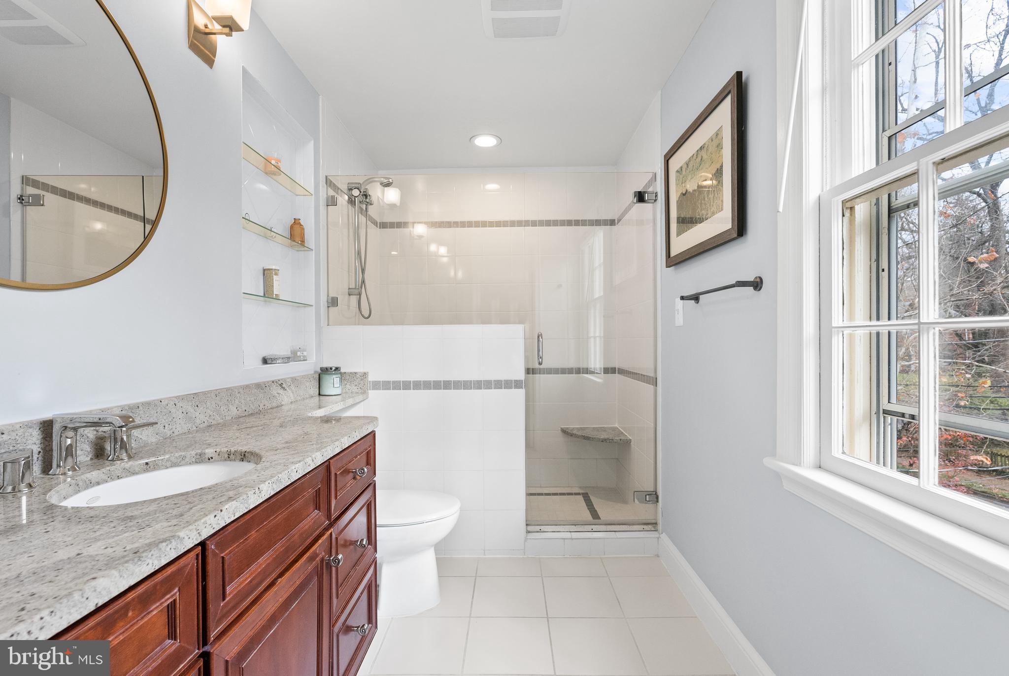 4213 Leland Street Chevy Chase, MD 20815 - Photo 16 of 33 a bathroom with a granite countertop sink toilet and shower