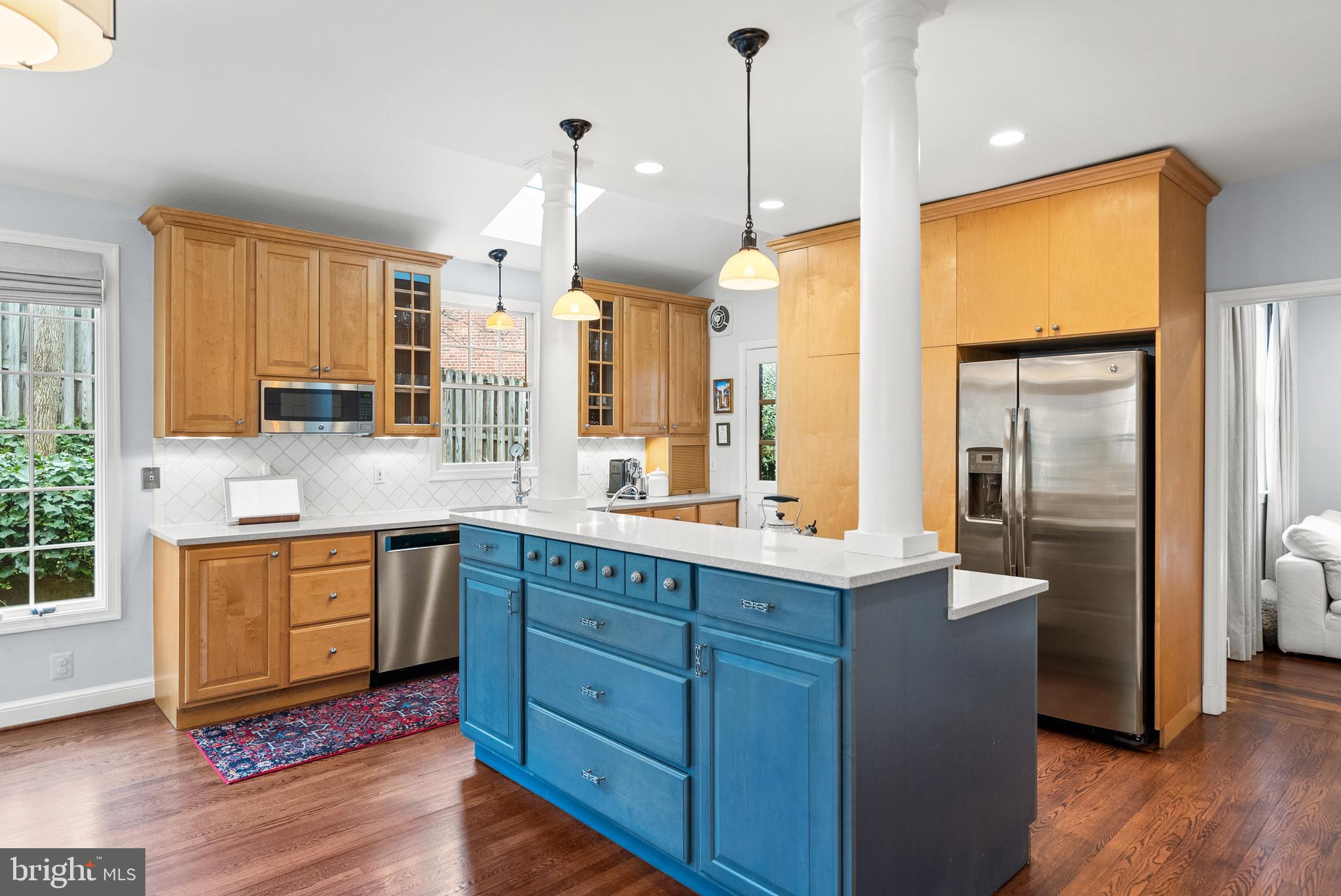 4213 Leland Street Chevy Chase, MD 20815 - Photo 6 of 33 a kitchen with stainless steel appliances granite countertop wooden floors and sink
