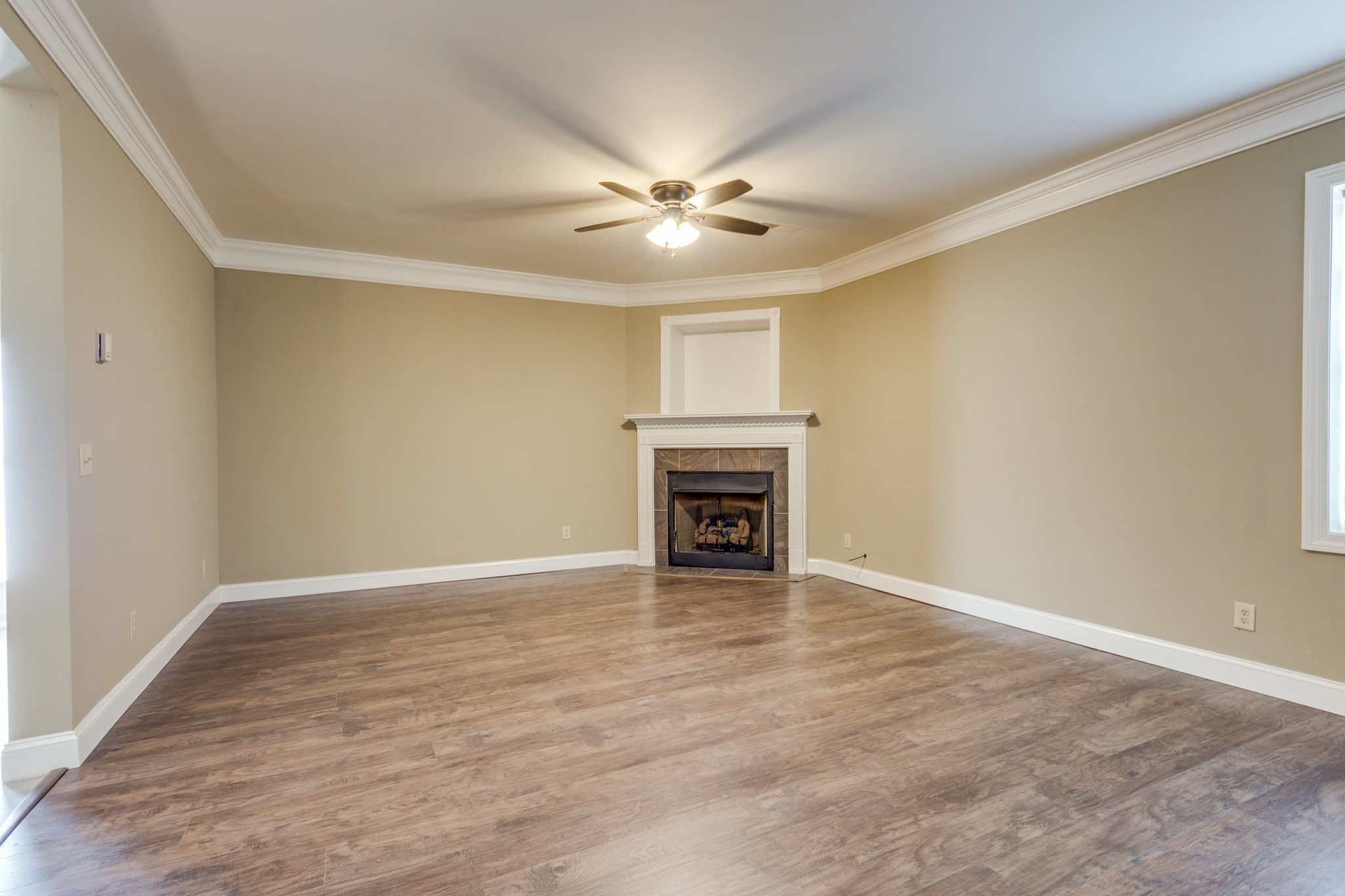 4655 Hardison Mill Road Columbia, TN 38401 - Photo 13 of 47 wooden floor in an empty room with a ceiling fan