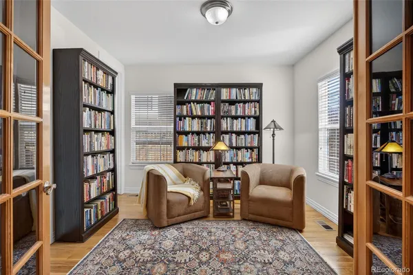 a living room with furniture and a book shelf