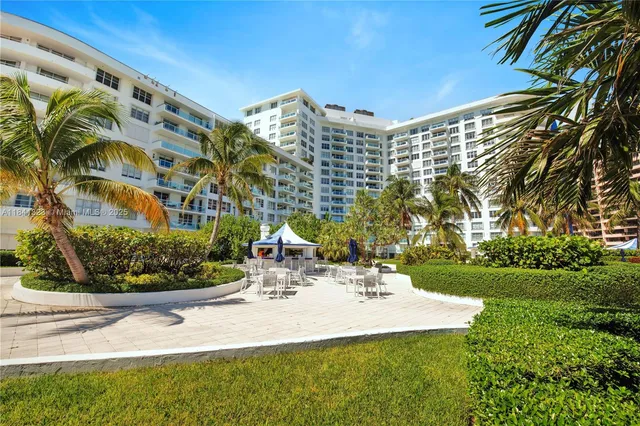 a view of a building with garden and patio