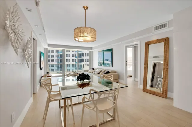 a view of a dining room with furniture wooden floor and chandelier
