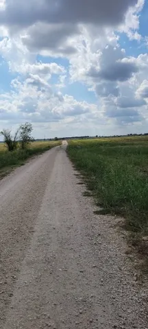 a view of a lake with beach in background