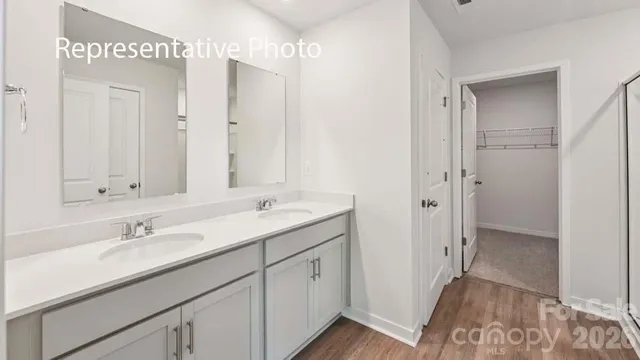 a bathroom with a sink double vanity and a mirror