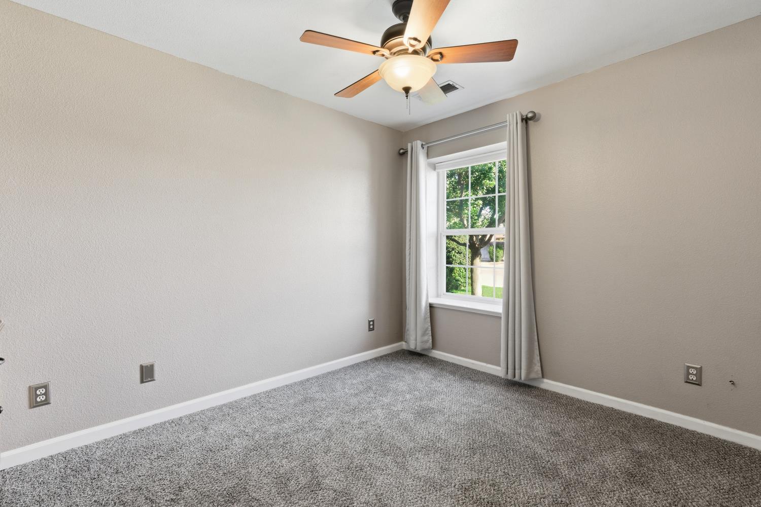 184 South Double Tree Way Madera, CA 93637 - Photo 15 of 37 an empty room with a window and a fan