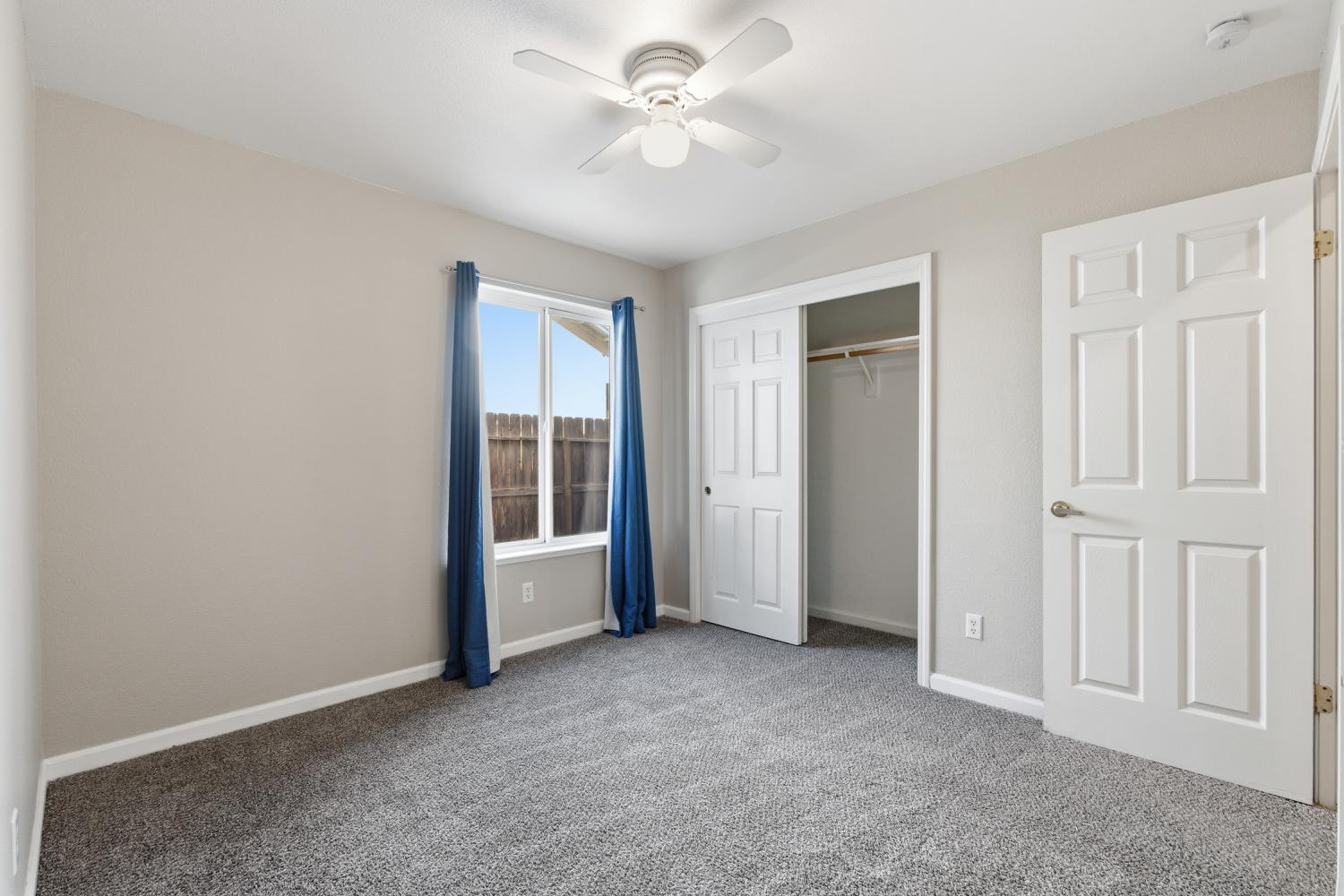 184 South Double Tree Way Madera, CA 93637 - Photo 18 of 37 an empty room with windows and fan