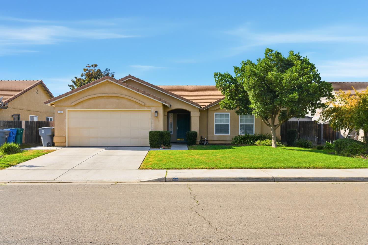 184 South Double Tree Way Madera, CA 93637 - Photo 2 of 37 a front view of a house with a yard and garage