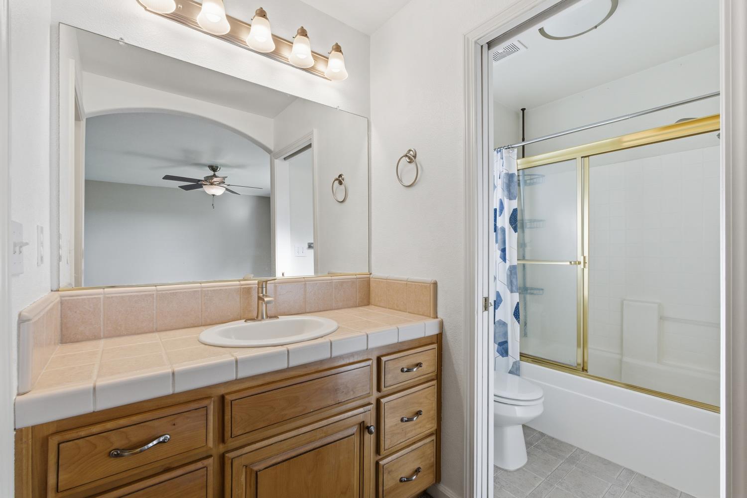 184 South Double Tree Way Madera, CA 93637 - Photo 21 of 37 a bathroom with a sink a toilet and shower