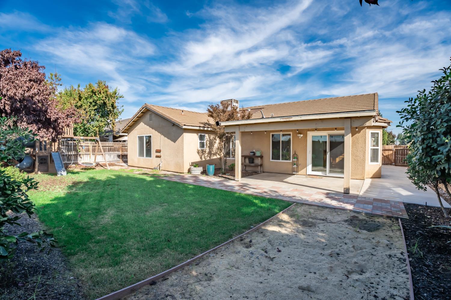 184 South Double Tree Way Madera, CA 93637 - Photo 26 of 37 front view of a house with a yard