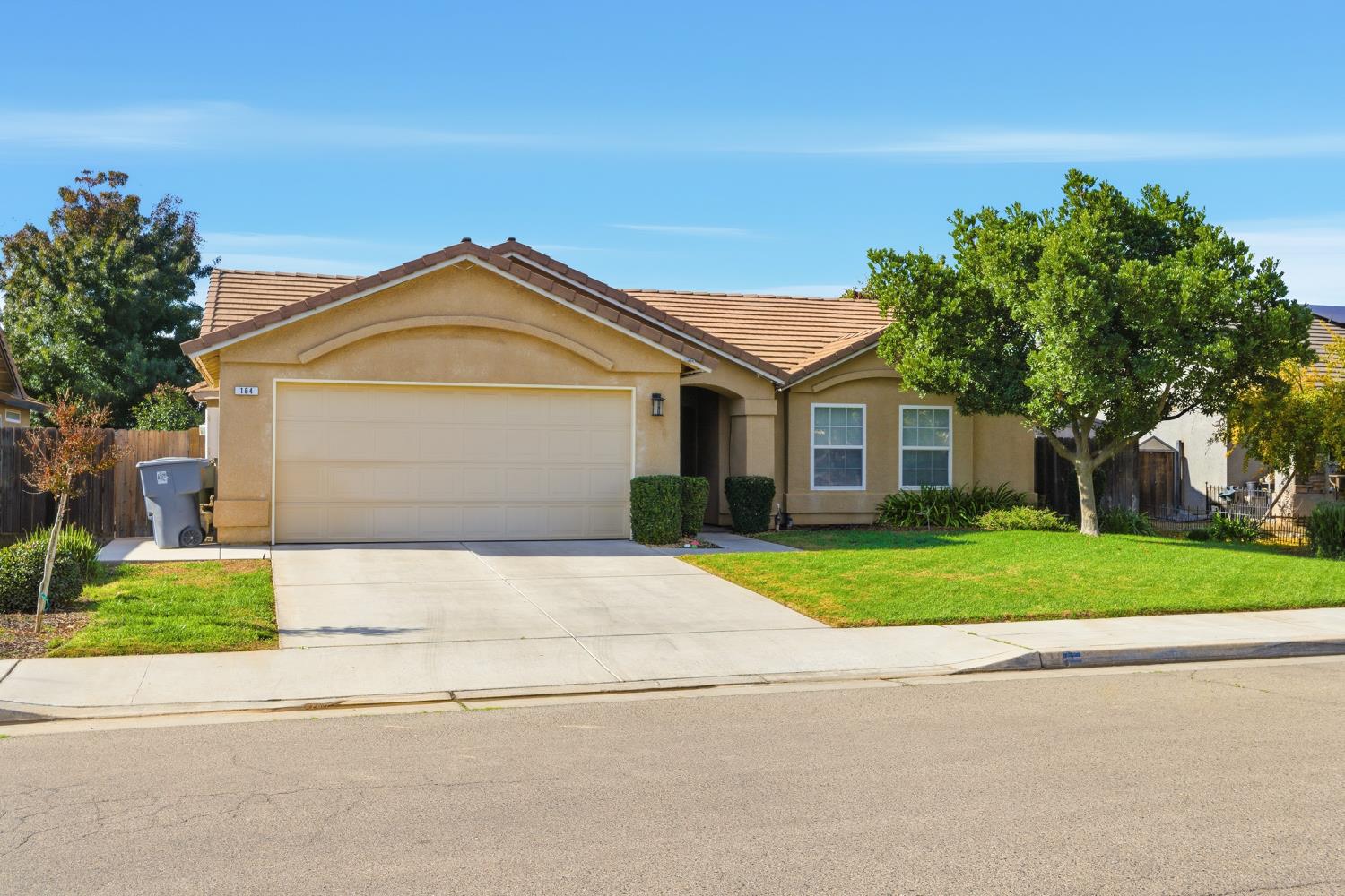 184 South Double Tree Way Madera, CA 93637 - Photo 30 of 37 front view of a house with a yard