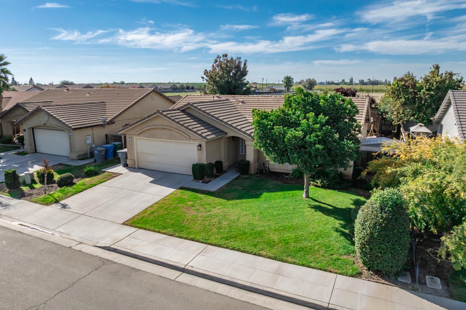 184 South Double Tree Way Madera, CA 93637 - Photo 31 of 37 a aerial view of a house with a yard and potted plants