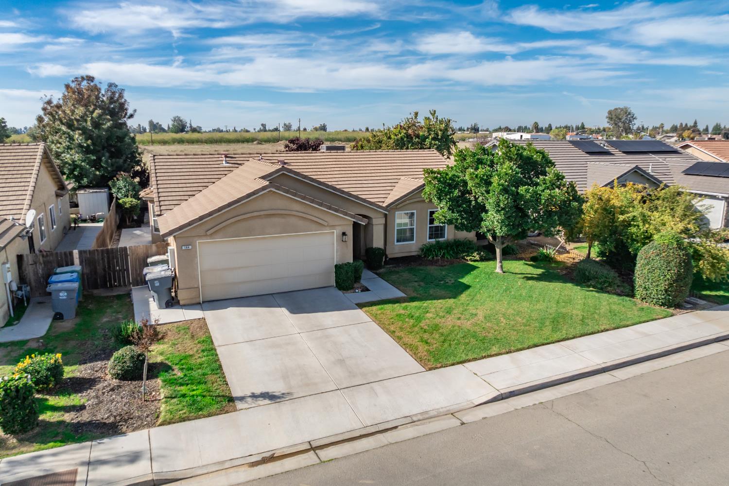 184 South Double Tree Way Madera, CA 93637 - Photo 33 of 37 a view of a house with a yard and potted plants