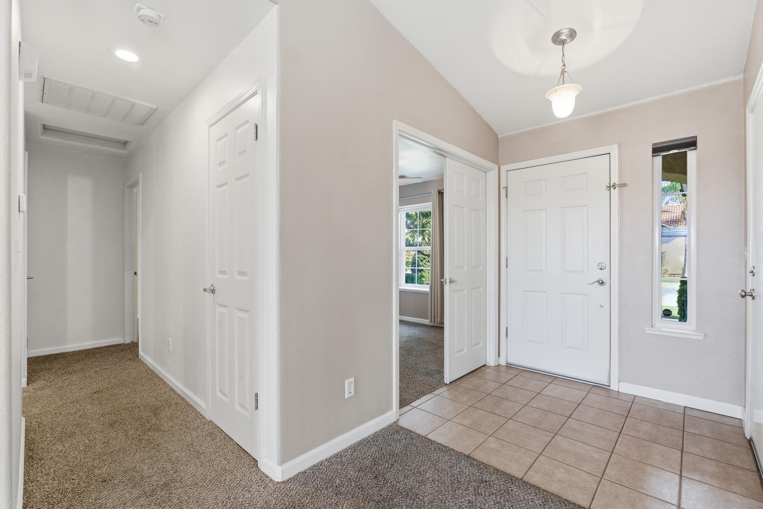 184 South Double Tree Way Madera, CA 93637 - Photo 4 of 37 a view of a hallway with closet and a chandelier fan