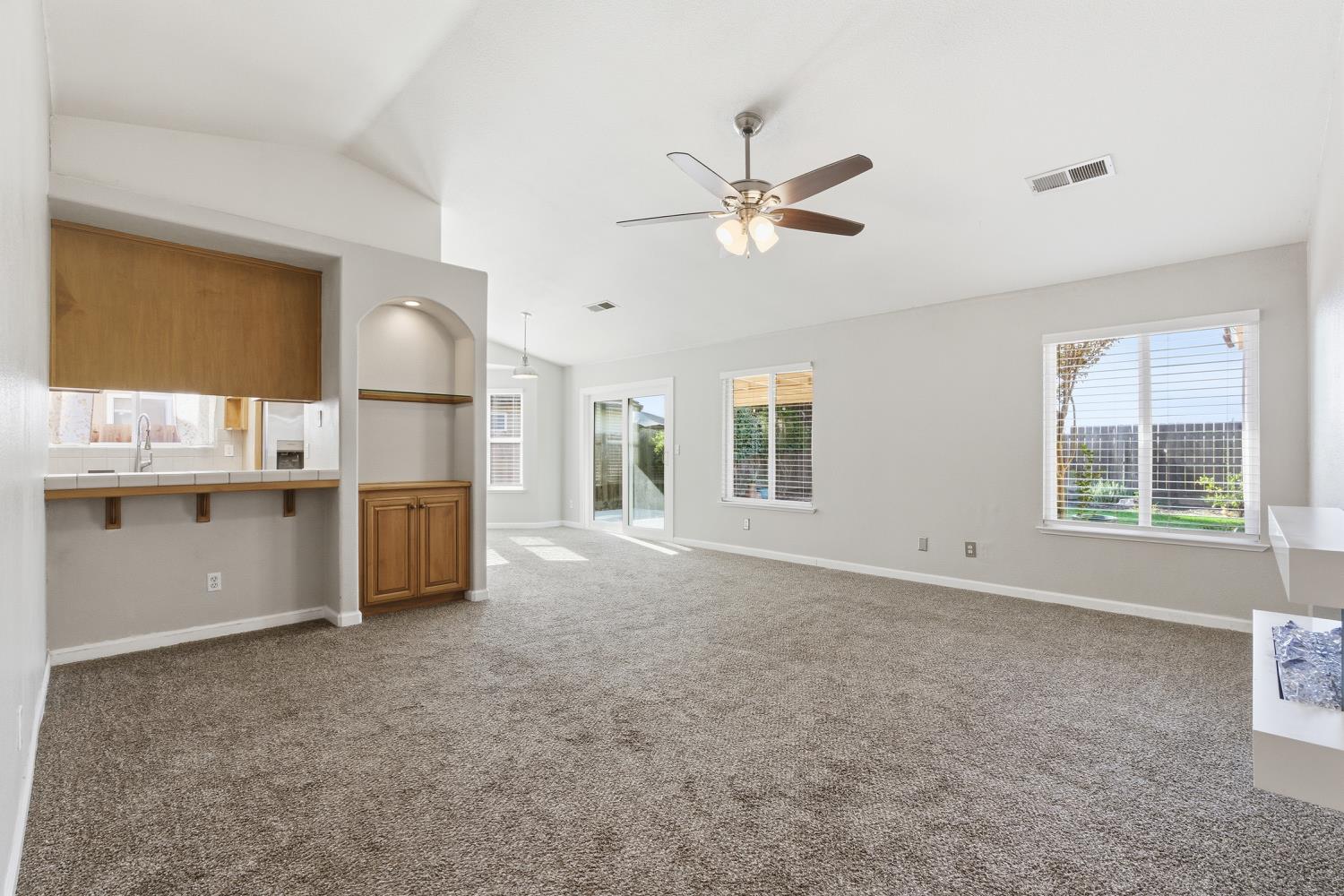 184 South Double Tree Way Madera, CA 93637 - Photo 5 of 37 a view of a livingroom with a ceiling fan and window