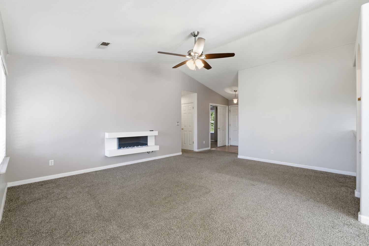 184 South Double Tree Way Madera, CA 93637 - Photo 7 of 37 a view of an empty room with a ceiling fan