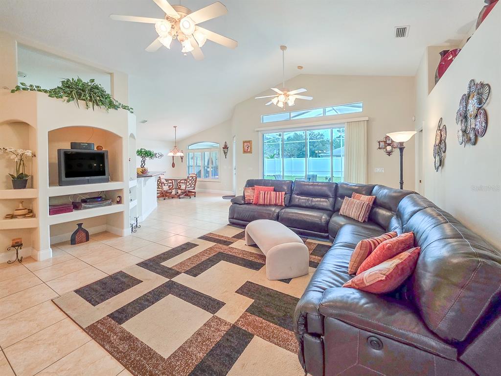 1 Ripley Place Palm Coast, FL 32164 - Photo 14 of 54 a living room with furniture a fireplace and a flat screen tv