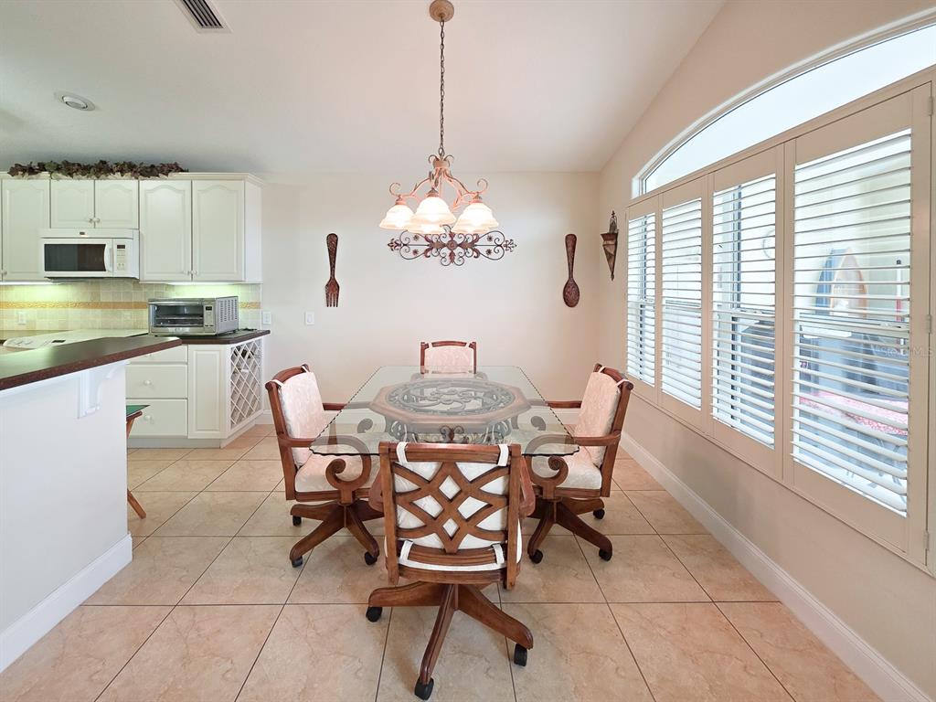 1 Ripley Place Palm Coast, FL 32164 - Photo 16 of 54 a dining room filled chandelier and kitchen view
