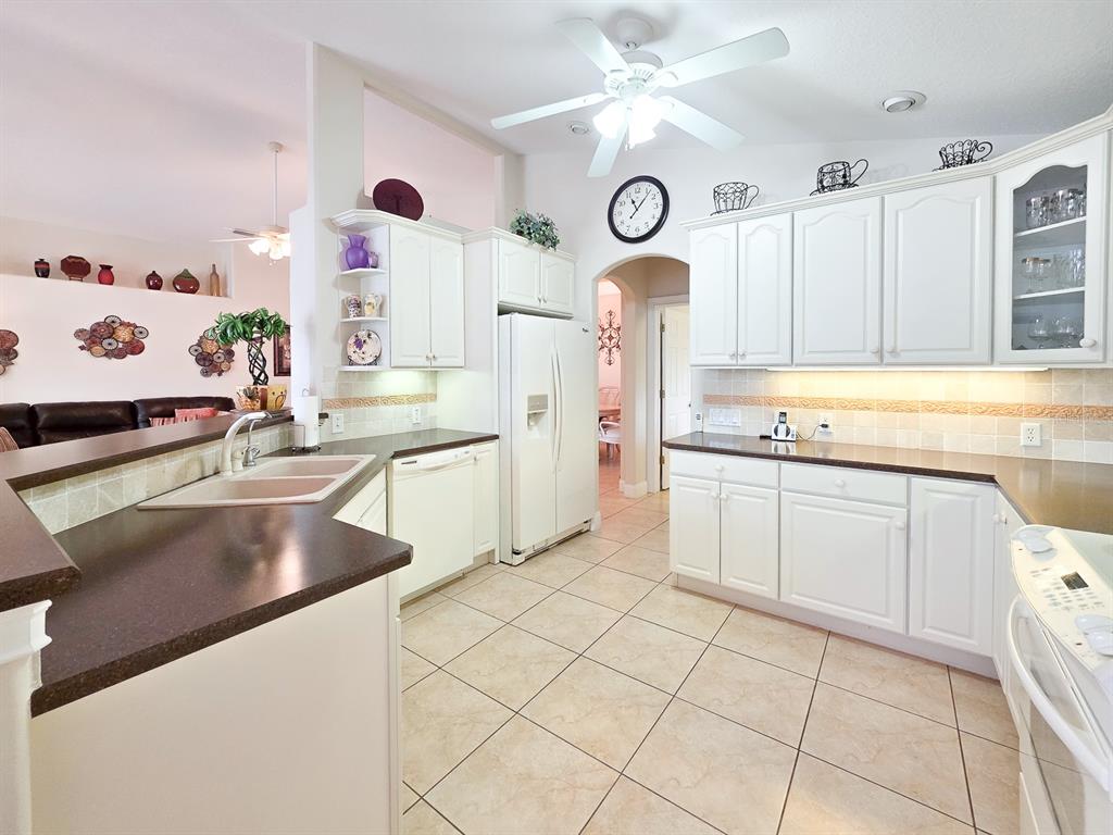 1 Ripley Place Palm Coast, FL 32164 - Photo 18 of 54 a kitchen with stainless steel appliances granite countertop a sink a stove and a clock on the cabinets