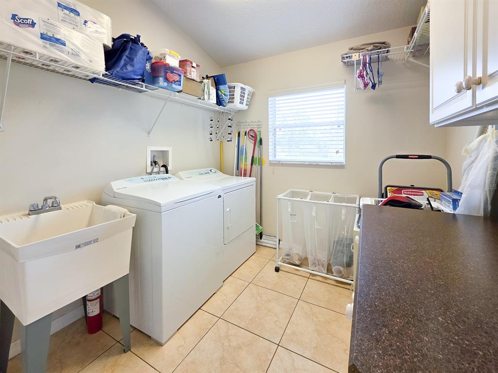 1 Ripley Place Palm Coast, FL 32164 - Photo 22 of 54 a utility room with sink dryer and washer