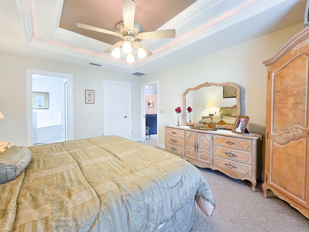 1 Ripley Place Palm Coast, FL 32164 - Photo 25 of 54 a bedroom with a bed and a chandelier