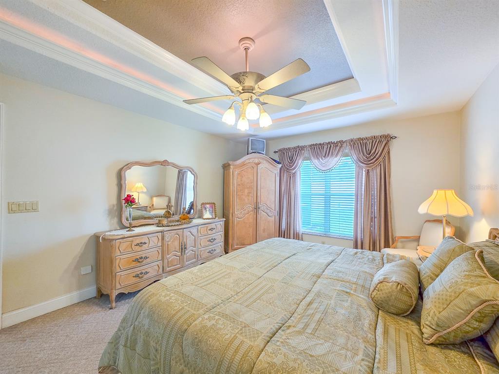 1 Ripley Place Palm Coast, FL 32164 - Photo 26 of 54 a bedroom with a bed and a chandelier